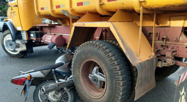 Motocicleta fica prensada entre rodas de caminhão na cidade de Patos de Minas