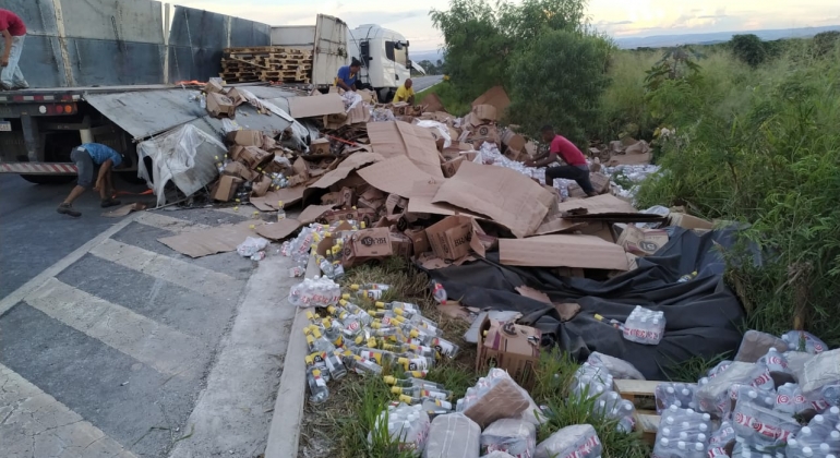 Carreta tomba na BR-146 e carregamento de cachaça fica espalhado pela rodovia 